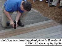 Pat Donahoe installing last plank in Centennial Boardwalk
